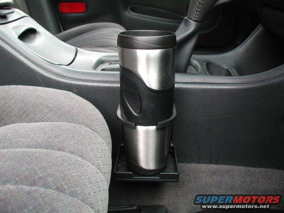 Cup holder with travel mug in car interior