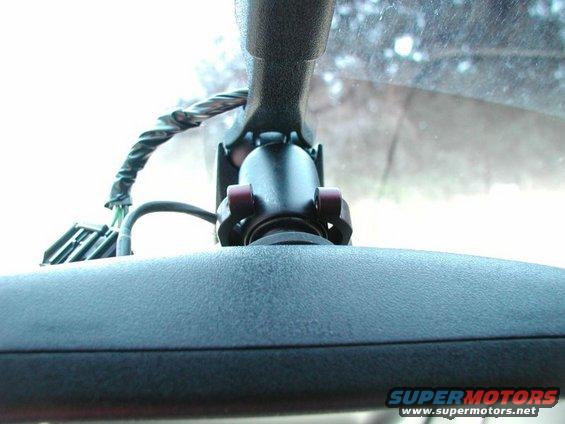 Close-up of rear-view mirror mount showing wiring harness and connector