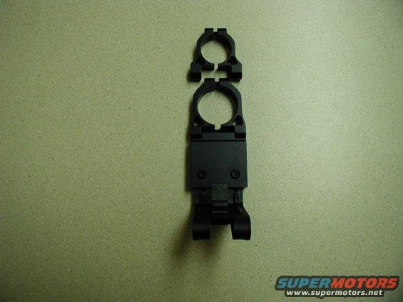 Black radar detector mount with two rings on a speckled surface