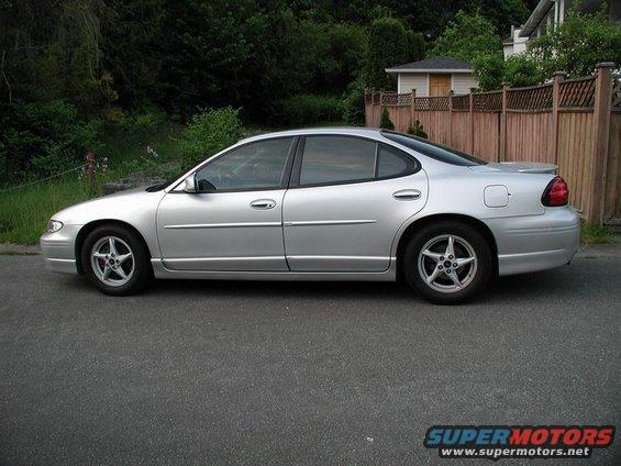 Silver 2002 Pontiac Grand Prix sedan parked on asphalt, side view