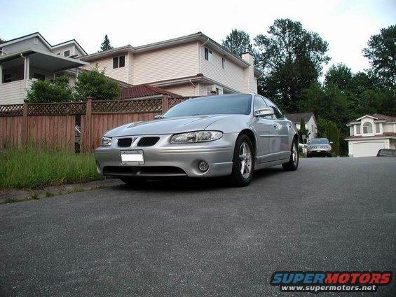 Silver 2002 Pontiac Grand Prix parked on a residential street