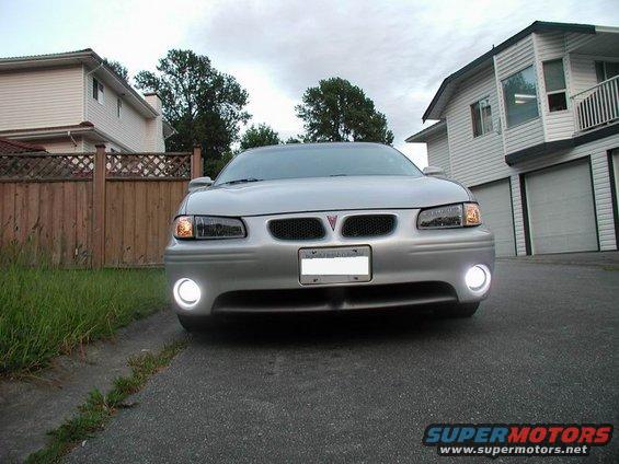 Silver 2002 Pontiac Grand Prix front view, with fog lights on