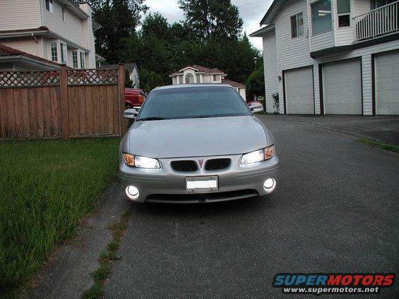 Silver 2002 Pontiac Grand Prix sedan parked in driveway, front view