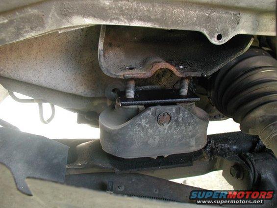Engine mount with black bracket installed on underside of vehicle