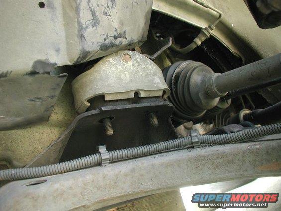 Close-up of a vehicle's engine mount and CV axle assembly