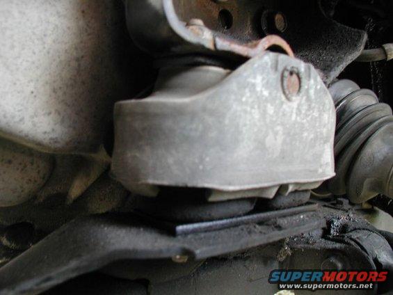 Close-up of a vehicle's engine mount with rubber and metal components