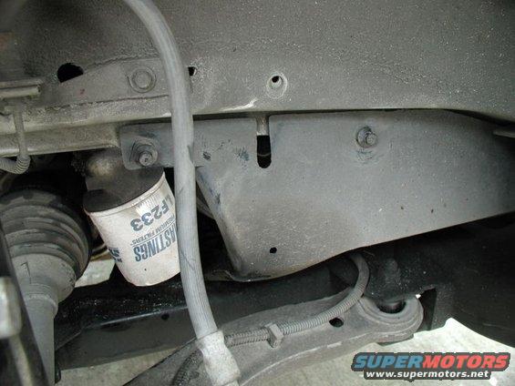 oil filter labeled F233 and part of the suspension system