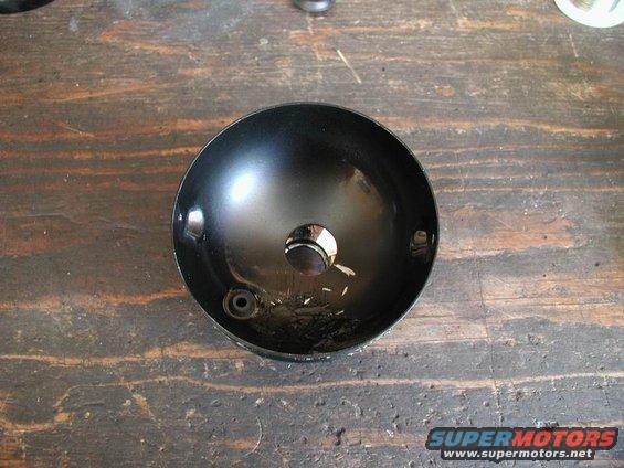 Black sphere on wooden surface