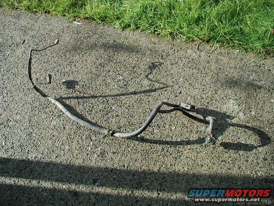 automotive wiring harness on asphalt with grass in background