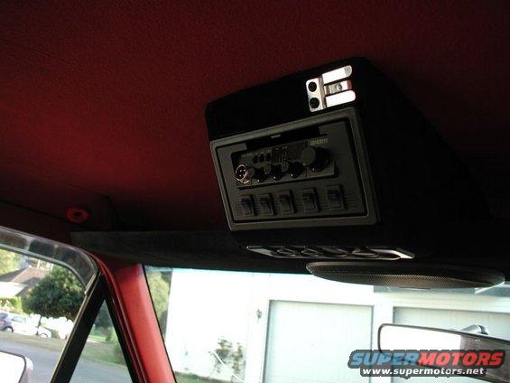 Overhead console with CB radio and multiple toggle switches. A speaker is visible below