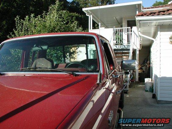 red pickup truck parked in driveway, front quarter view