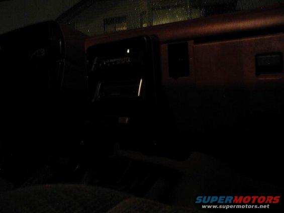 Interior of a dark vehicle, showing dashboard and seats