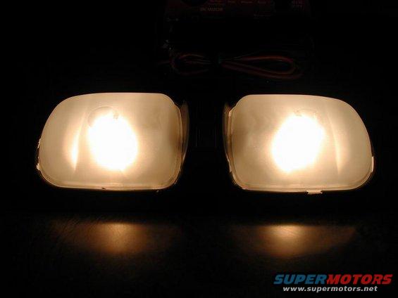 Two illuminated interior dome lights with wiring visible above