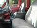 1990 Ford F-250 - The interior of a truck cab features a center console with cup holders and a bench seat.