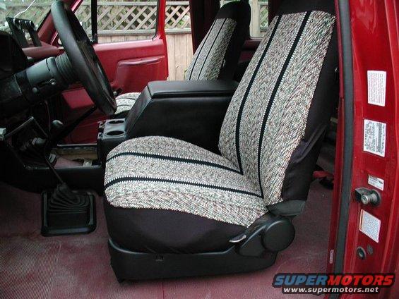 Interior of a 1990 Ford F-250 with patterned seat covers and a center console