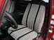 1990 Ford F-250 - Driver's seat interior of a 1990 Ford F-250 with custom patterned seat covers and a black steering wheel.