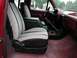 1990 Ford F-250 - The interior of a truck shows newly installed seat covers with a patterned fabric over black bases.