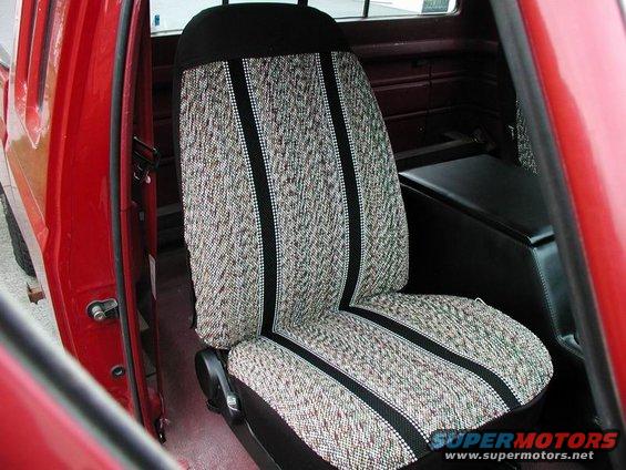 Red truck interior showing a patterned seat with black trim and a black console