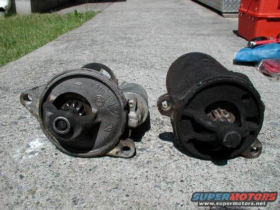 Two vehicle starters, one cleaner than the other, sit on a concrete surface
