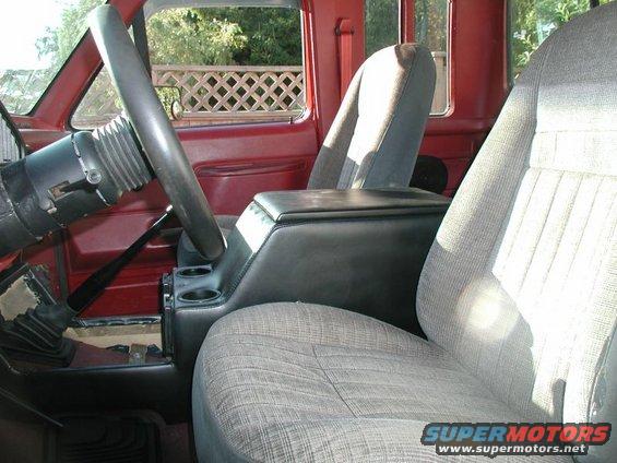 Pickup truck interior with bucket seats, center console, and steering wheel