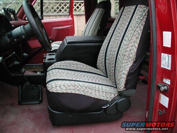 1990 Ford F-250 interior with patterned seat covers and a black center console