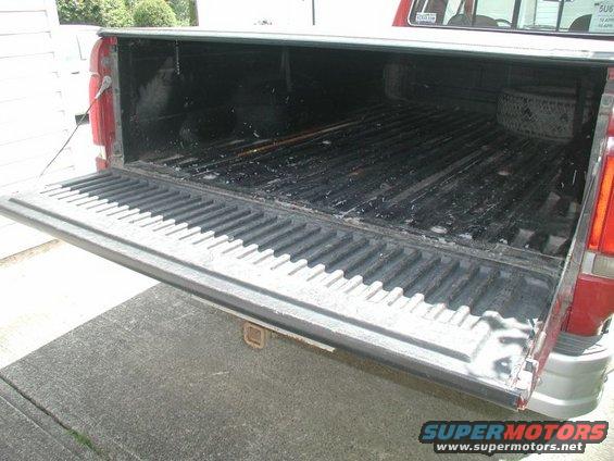 1990 Ford F-250 tailgate down, showing truck bed and spare tire
