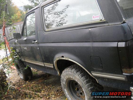 Black 1990 Ford Bronco, 3/4 front view, showing rust on wheel well