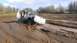 1995 Ford Bronco - Pickup truck struggling in muddy terrain, with another vehicle in the distance.