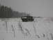1987 Ford Bronco - A military dump truck navigates a snow-covered field during a winter day.