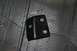 1976 Ford Ranchero - A close-up view of a black metal bracket with multiple mounting holes.