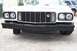 1976 Ford Ranchero - The front of a white 1976 Ford Ranchero is visible, showing its grille and bumper.