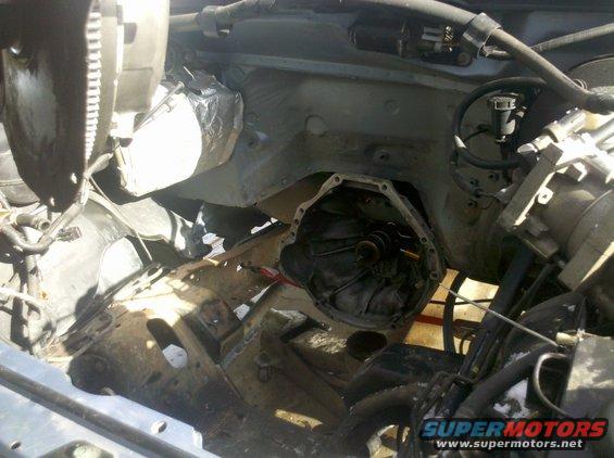 Had to replace input shaft Seal on the Mazda Dog.
13mm bolts, cover comes off. There is a metal sleeve on the bottom and upper has a seal. NO gasket, just rtv held it on.  Removing the seal you need to punch it inside towards trans, not outward like an engine seal the flange on mine chipped as it was to late but only a small bit.