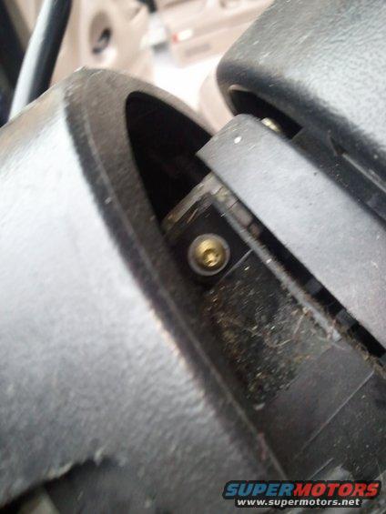 Close-up of interior plastic trim and screw mechanism