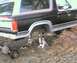 1984 Ford Bronco - This 1984 Ford Bronco is shown with its rear axle removed, indicating a repair or modification is underway.