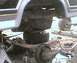 1984 Ford Bronco - Close-up of a vehicle's rear axle and suspension components, with a SuperMotors logo.