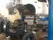 2004 Ford F-350 - Truck undergoing service with front end raised on a lift, revealing the chassis and engine components.