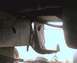 1984 Ford Bronco - A close-up view of a vehicle's frame and an attached metal bracket, with a website logo in the lower right corner.