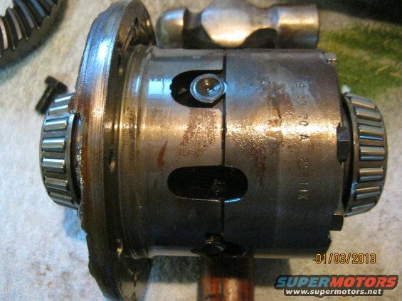 Differential carrier with roller bearings and part of a gear visible. Stamped '70 A 26211X'
