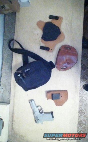 Silver pistol with leather holsters and a black bag