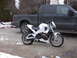 2003 Buell Lightning w/Fairing - A white Buell motorcycle is parked next to a black pickup truck on a concrete driveway.