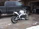 2003 Buell Lightning w/Fairing - A white Buell motorcycle is parked in front of a black pickup truck in a driveway.