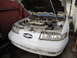 1992 Ford Taurus - Front view of a white 1992 Ford Taurus SHO with its hood open, revealing the engine compartment.