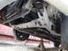 1992 Ford Taurus - The underside of a vehicle is visible, supported by jack stands, revealing mechanical components.