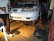 1992 Ford Taurus - Front view of a 1992 Ford Taurus undergoing repairs, with the transmission removed.