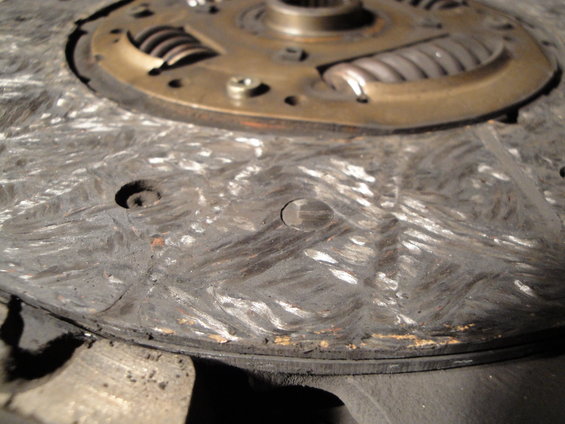 Worn clutch disc with visible scoring and springs
