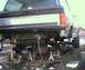 1984 Ford Bronco - The rear axle and suspension of a truck are visible as it is supported by jack stands.