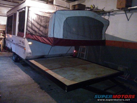 Pop-up camper trailer with extended deck