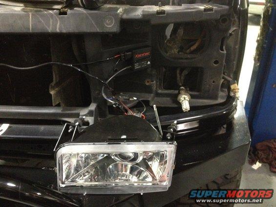 Headlight assembly with wiring and ballast, angled from front