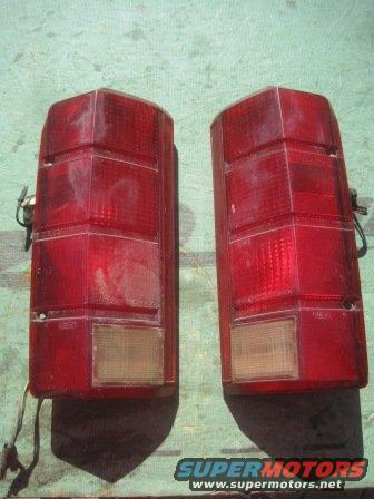 Two red taillights, likely for a truck or SUV, shown from the back