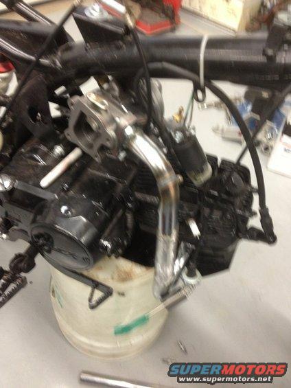 Motorcycle engine with exhaust pipe and carburetor